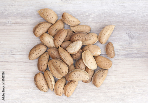 Close up of a bunch of raw almonds in their shells photo