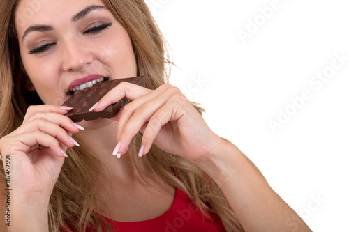 young and beautiful woman eating a delicious dark chocolate