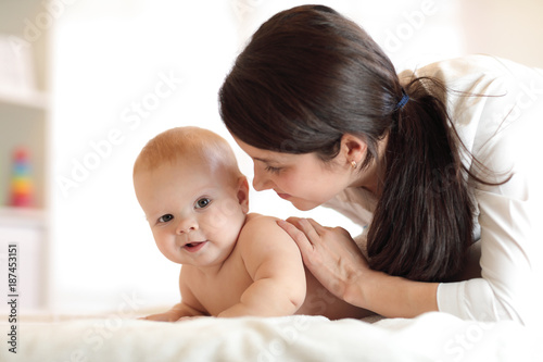 Happy baby near to mom in room