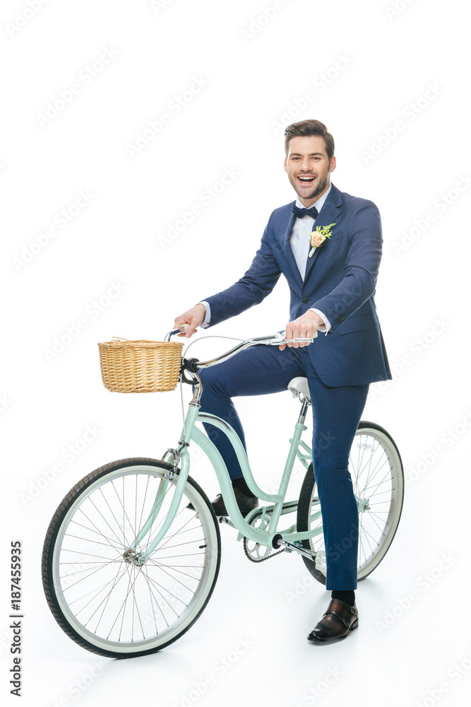 cheerful groom riding retro bicycle isolated on white cheerful groom riding retro bicycle isolated on white