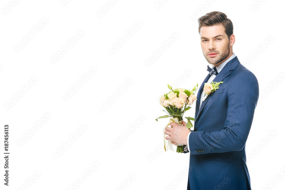portrait of stylish groom in suit with wedding bouquet isolated on white portrait of stylish groom in suit with wedding bouquet isolated on white