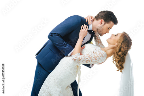 young bride and groom dancing together isolated on white