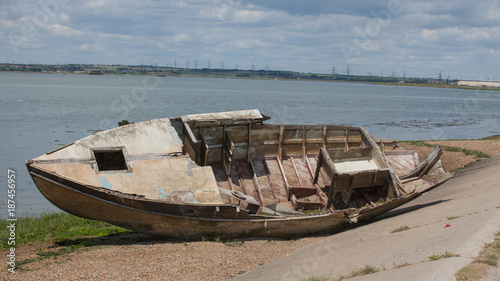 photo of an old wooden boat rooting away