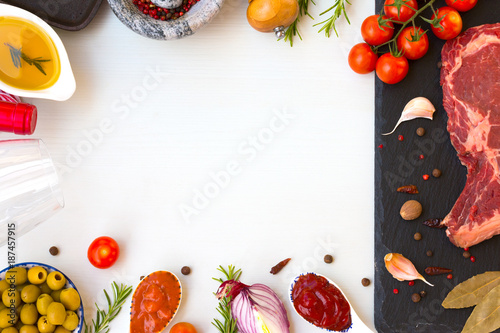 Fresh raw beef entrecote with ingredients to cooking taesty dinner, top view with space for text . photo