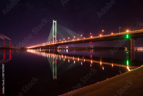 Fototapeta Naklejka Na Ścianę i Meble -  Night city. Beautiful glowing bridge over the river