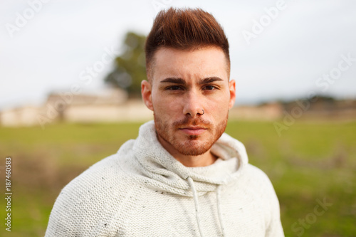 Attractive guy with beard in the meadow
