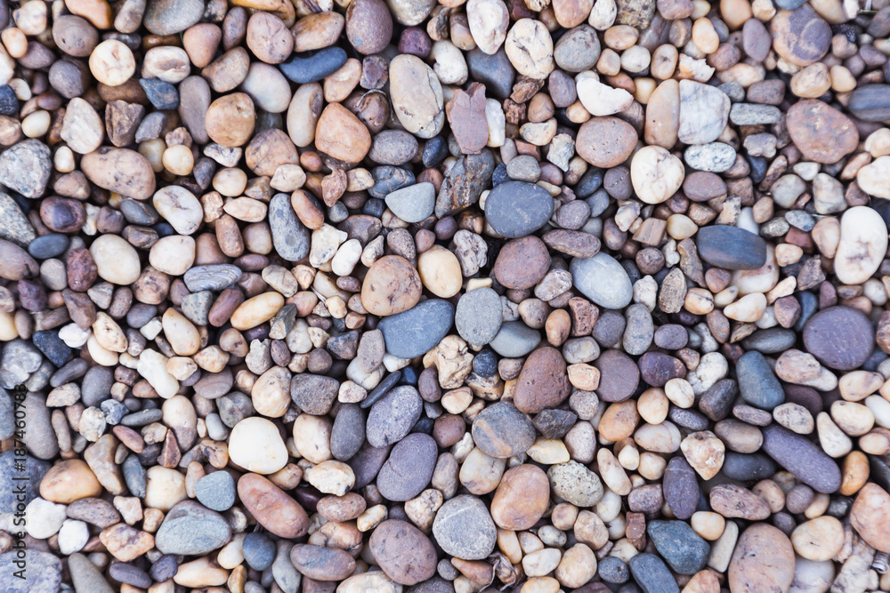 Naklejka premium Stone pebbles texture or stone pebbles background for interior design business. exterior decoration and industrial construction idea concept design. Stone pebbles motifs that occurs natural.