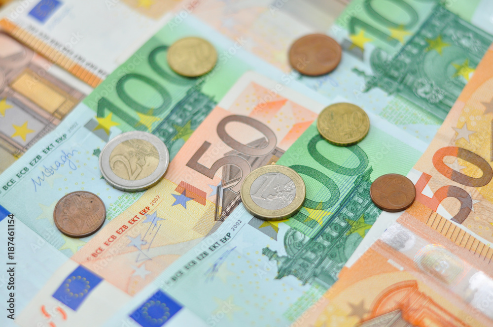 Euro coins over paper euro banknotes. Euro money banknote, business and finance concept Euro coins over paper euro banknotes. Euro money banknote, business and finance concept