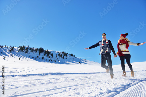 Couple having fun running down slope