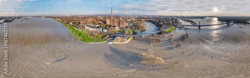 Fotografie, Tablou Aerial view of the skyline of the city of Duisburg during the Flooding of Januar