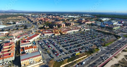 Aerial: vertical view of cars and shopping center parking lot