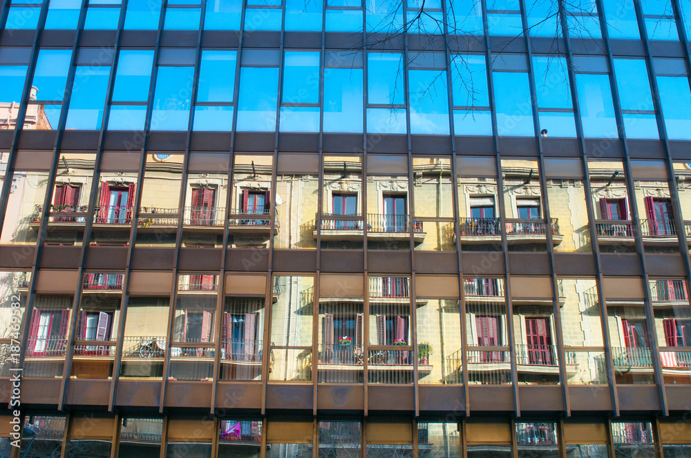 Windows of a building with reflected house