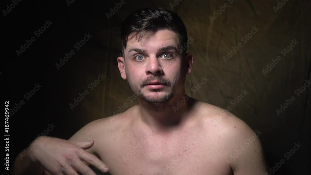 A bearded man covers his face with his hands, grimaces and shows a squint, slow motion shooting A bearded man covers his face with his hands, grimaces and shows a squint, slow motion shooting