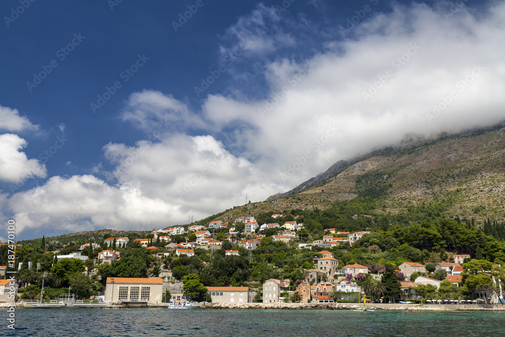 The town of Mlini in Croatia with clouds in the background.