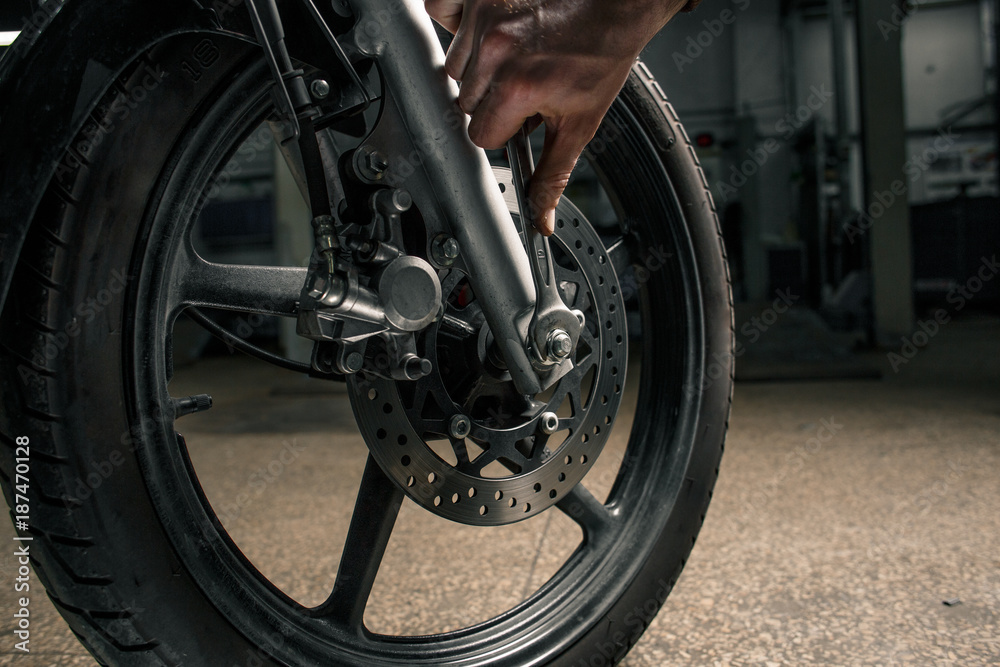 Close up of hand with key near the motorcycle's vehicle