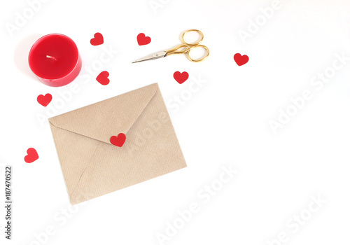 Valentines day or wedding mockup scene with envelope, paper hearts confetti, red candle, golden scissors on white background. Love concept. Flat lay, top view. Empty space for your text.
