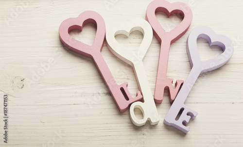 Happy Valentines Day background, key hearts. Copy space on wood