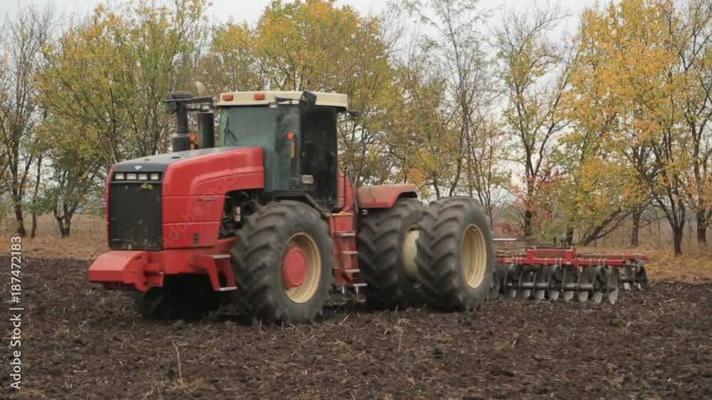 Tractors preparing land for sowing, the tractor is digging the earth Tractors preparing land for sowing, the tractor is digging the earth