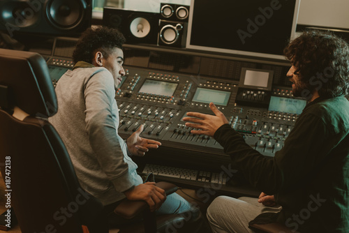 young musicians talking at recording studio © LIGHTFIELD STUDIOS
