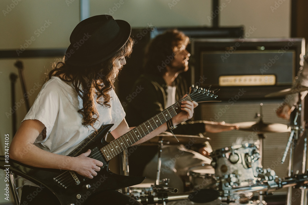 Fototapeta premium young rock band musicians performing song on repetition