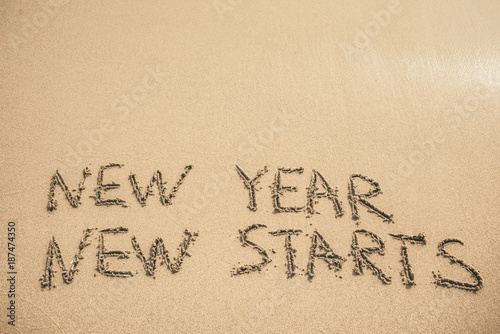 New Year New Starts text written on the sand © anastasiapelikh