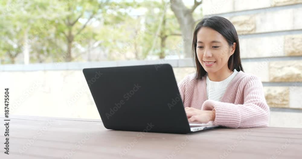Woman use of notebook computer at outdoor Woman use of notebook computer at outdoor