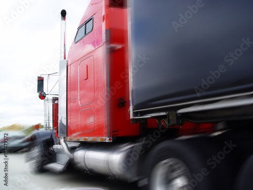 Danger on the road, a huge truck in city traffic