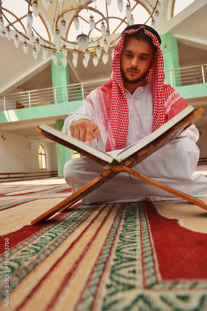 Fototapeta premium Religious muslim man praying inside the mosque