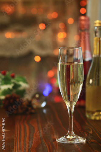 A glass of Sparkling wine in front of defocused colorful lights, evening warm tone background_2