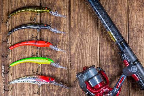 Fishing tackle - fishing spinning, hooks and lures on wooden background.Top view.