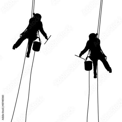 Silhouette of industrial climber washes windows on a white background