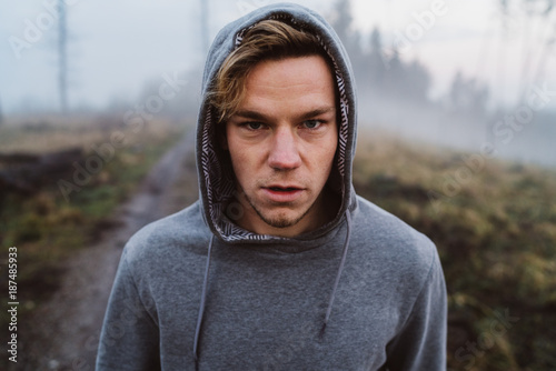 Young man looking focused in a forrest in Austria