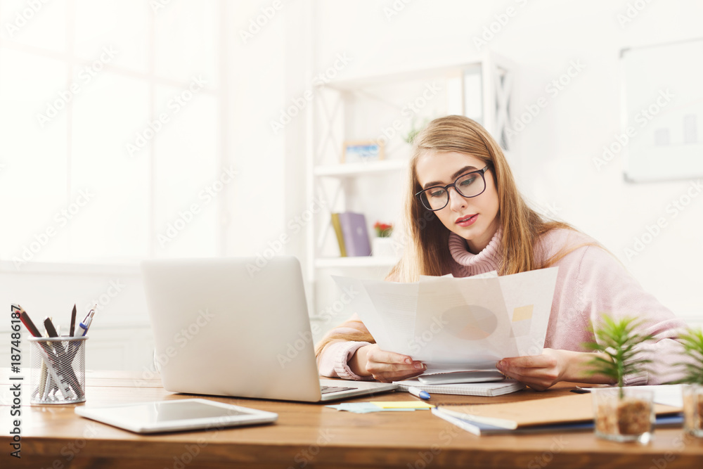 Business woman reading document at office Business woman reading document at office