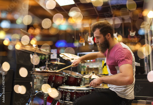 male musician playing cymbals at music store