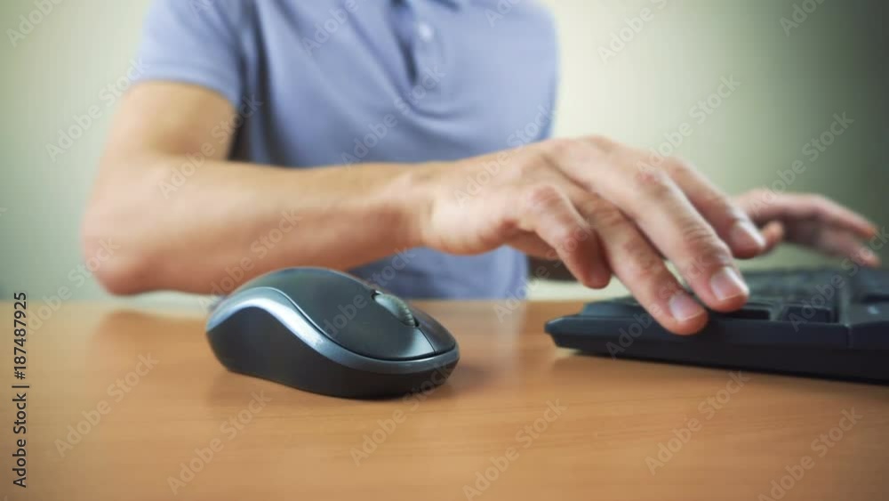 Close up of hands typing on computer keyboard and mouse Close up of hands typing on computer keyboard and mouse