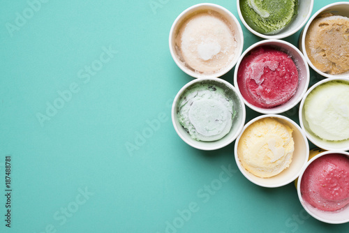 Top view Ice cream flavors in cup on green background