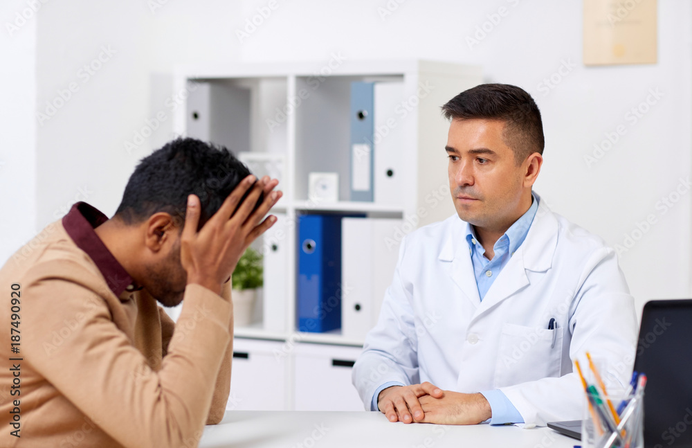 doctor and unhappy male patient at hospital