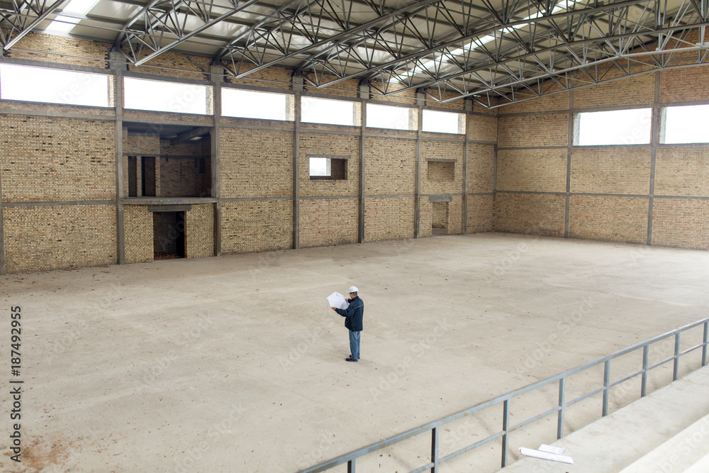 Senior construction manager controlling building site. Senior construction manager controlling building site.