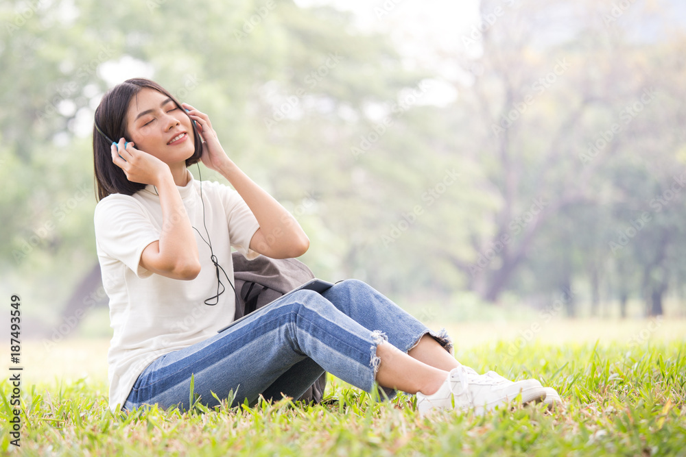 Asian Woman using tablet with attractive smiling at garden. People lifestyle concept. Asian Woman using tablet with attractive smiling at garden. People lifestyle concept.