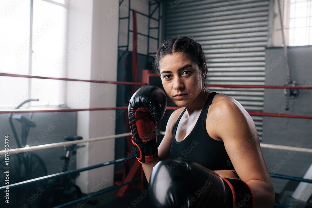 Female boxer training inside a boxing ring
