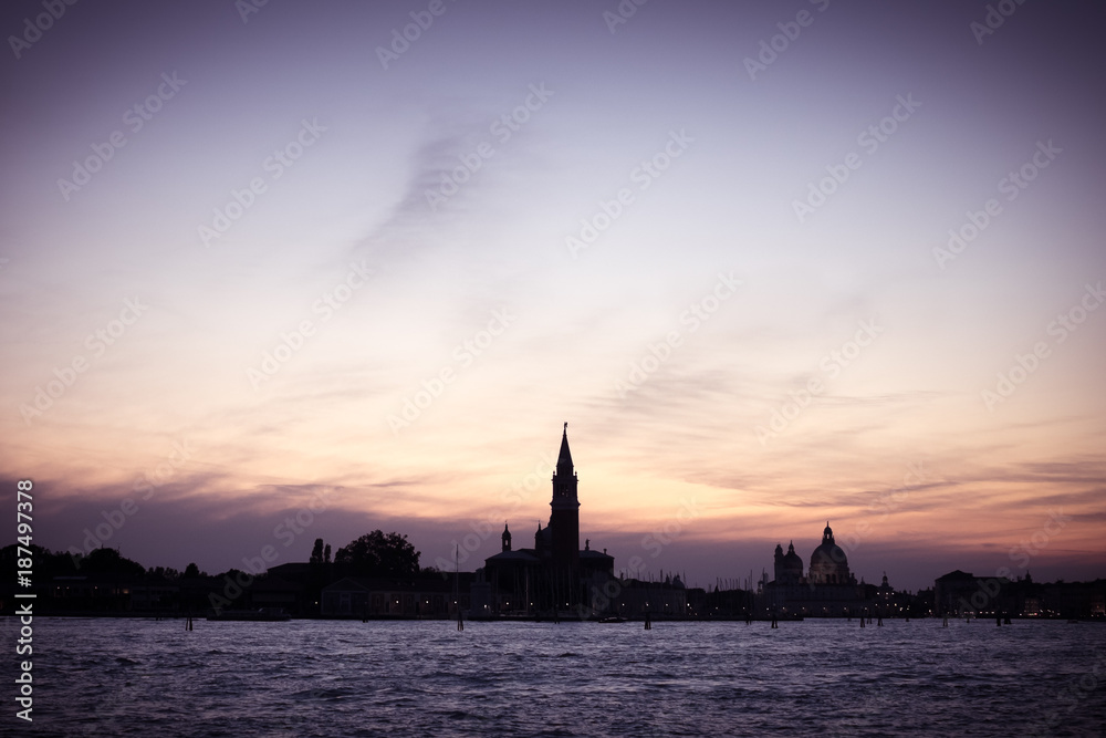 Italian silhouette of Venice sunset, City panorama shot from sea, Italian city panorama vintage shot from sea and sky, Sunset in Venice background, Dark scene of Venice, Symbol of evening Venice