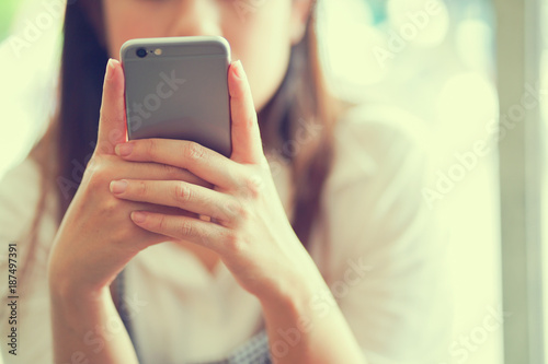 close up woman hand working on smartphone for checking news from email or playing social media in free time