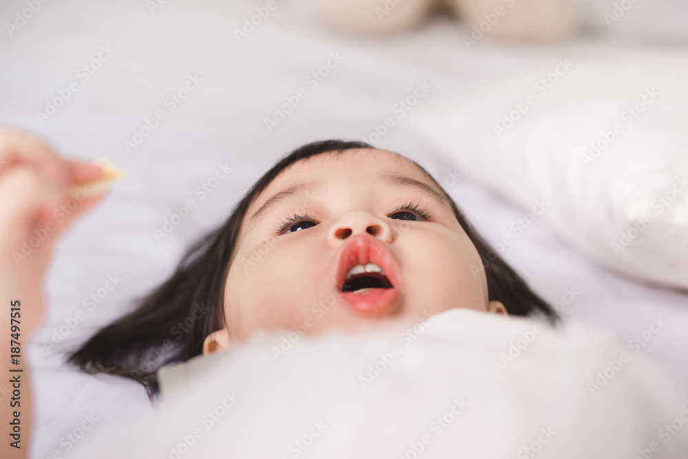 Cute little girl eating cookie at home Cute little girl eating cookie at home