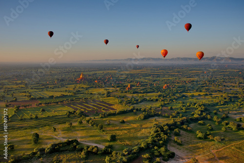 Bagan. Myanmar. 11/25/2016. Every morning at dawn, a dozen balloons carrying tourists rise together into the sky to see a bird's eye splendour of many ancient Buddhist temples of Bagan.