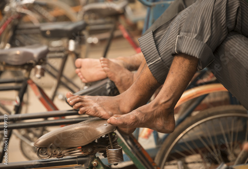 feet of resting rickshaw riders india