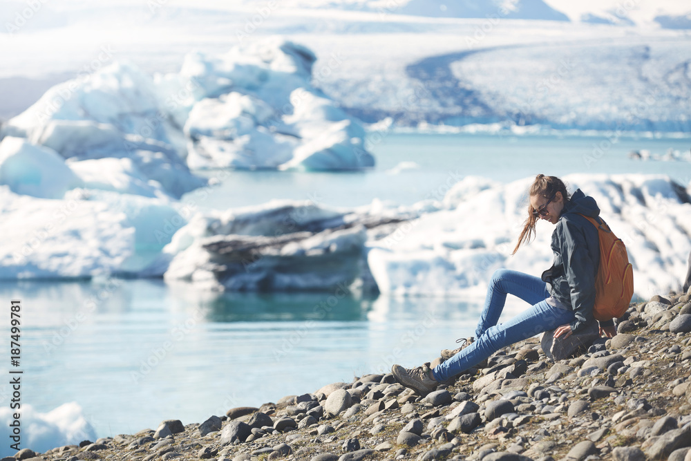 Woman with backpack in Ice Lagoon in Iceland