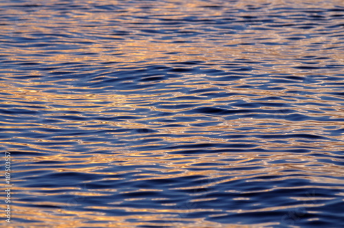 Sun reflections on water surface at sunset
