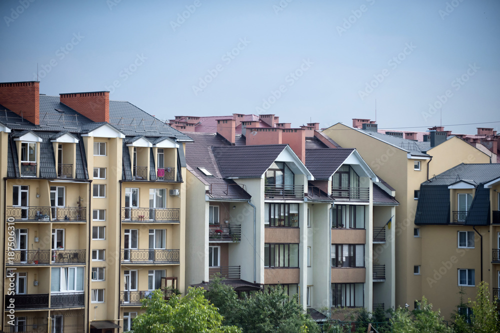 Houses in residential district on blue sky background