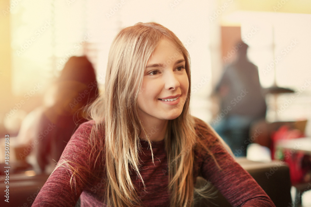 Portrait of beautiful smiling young woman in cafe Portrait of beautiful smiling young woman in cafe