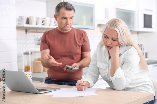 Mature couple managing fami...